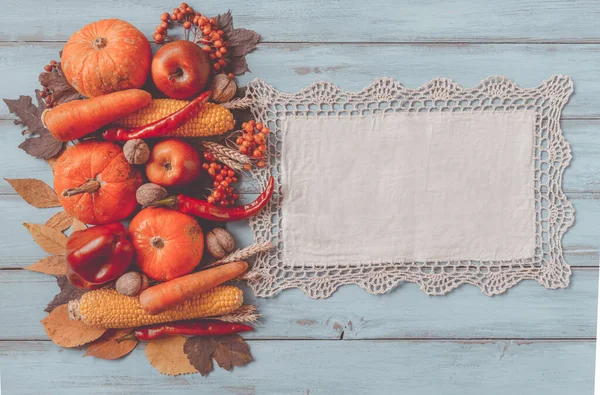 Autumn background set, fallen leaves, fruits, vegetables, wooden table. Seasonal side composition, aged vintage linen napkin, copy space. Thanksgiving food, healthy and fresh, top view, flat lay.