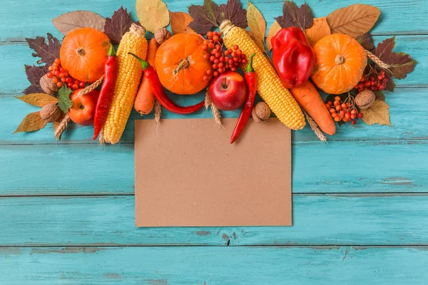 Autumn background set, fallen leaves, fruits, vegetables, wooden table. Seasonal side composition, aged vintage paper, copy space. Thanksgiving food, healthy and fresh, top view, flat lay.