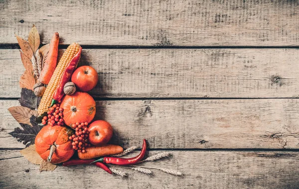 Autumn background set, fallen leaves, fruits, vegetables, wooden table. Seasonal side composition, aged vintage, copy space. Thanksgiving food, healthy and fresh, top view, flat lay.