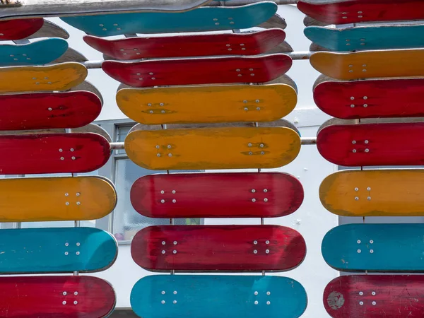 Some Red Orange Teal Skateboard Decks Mounted Installation — Stock Photo, Image