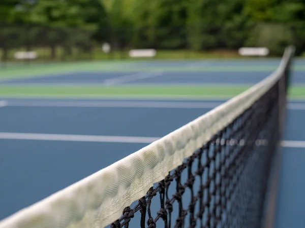 A close up of tennis court net with net in focus
