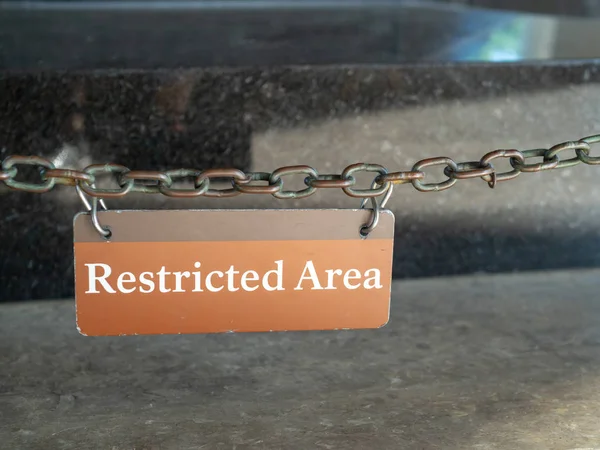 Restricted area sign hanging in front of a protected area — Stock Photo, Image