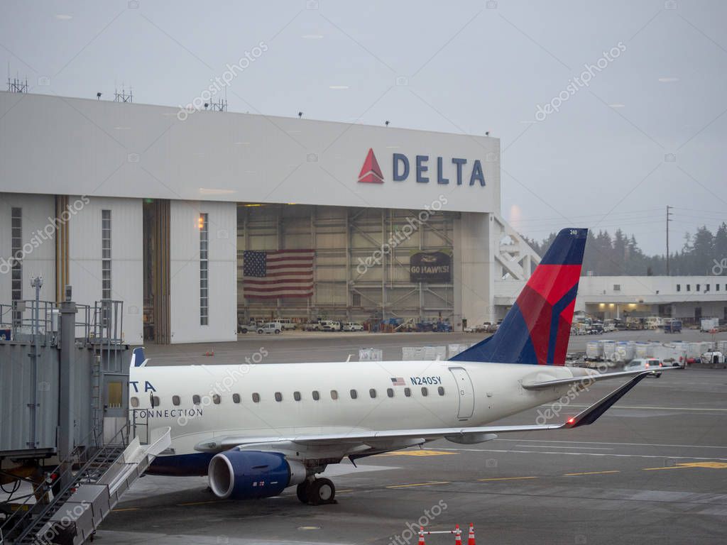 Seattle, WA AUGUST 26, 2018: Delta Airlines hanger and airplane at Seattle Tacoma International Airport terminal