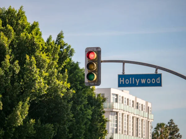 Hollywood Blvd street sign on traffic light at intersection at Los Angeles