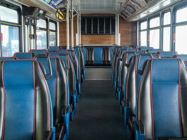 Rows of multiple leather blue empty seats on commuter bus