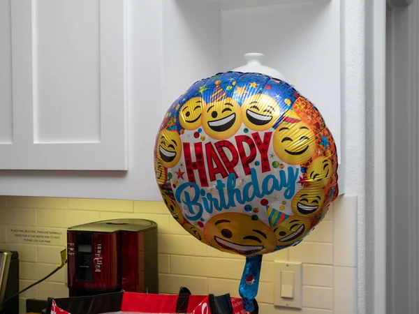 Happy birthday balloon with smile faces floating in a house ready for party — Stock Photo, Image