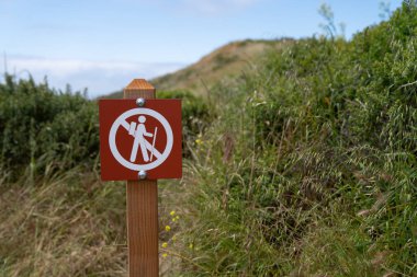 No hiking cross out warning sign in a dangerous area on trail clipart