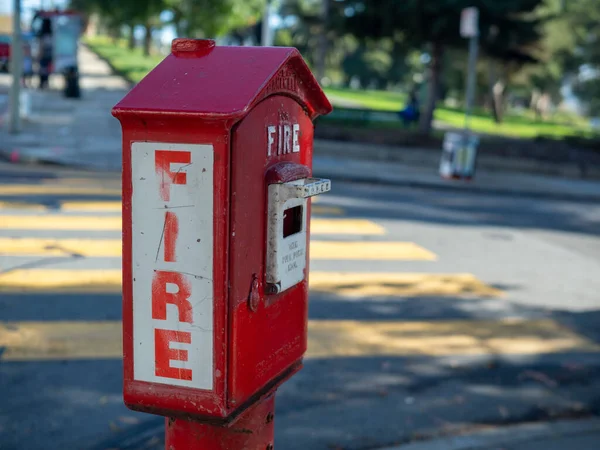 Outdoor fire alarm call box at urban intersection