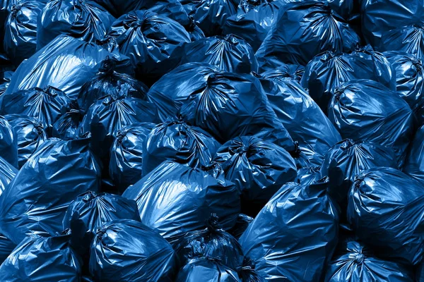 Background pile of trash bags, blue Bin,Trash, Garbage, Rubbish, Plastic Bags pile