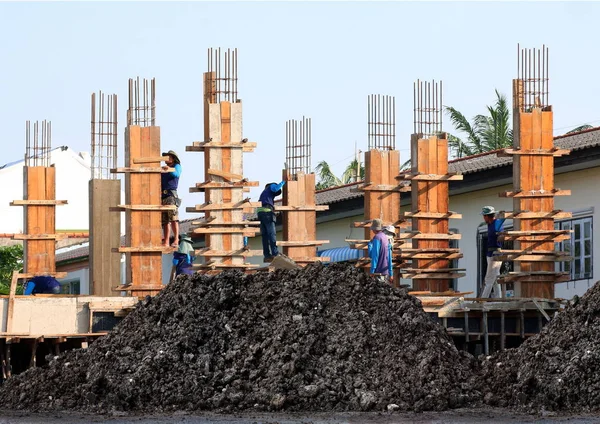 Soil mound, Clay wet black and Construction Site, Construction workers, People labor are working on construction building, Group of People are Professional teamwork construction worker, Labor worker