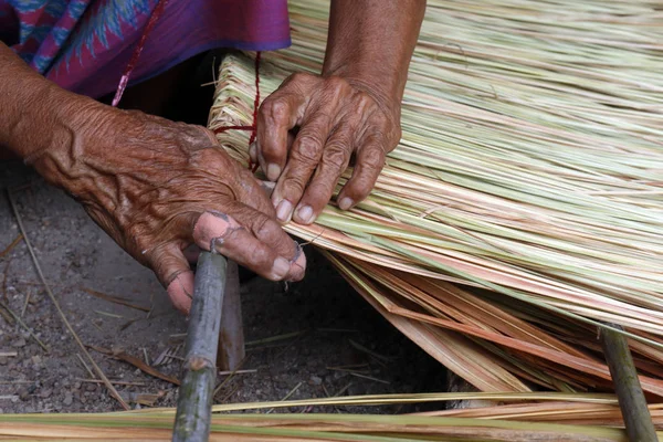 picture shows how to make a panel vetiver for hut roof, handwork crafts of panel vetiver for hut roof, straw roof hut