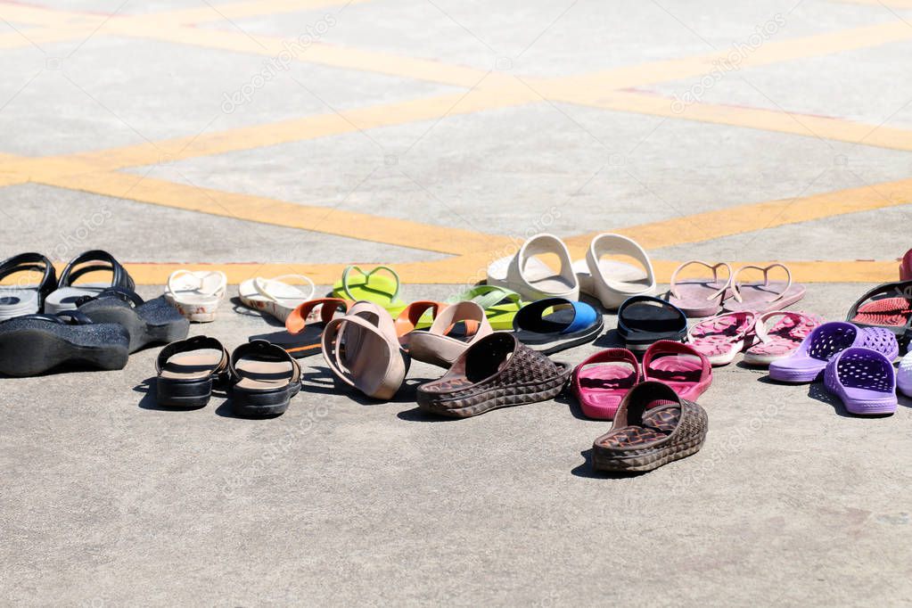 sandals shoes many heap on ground, lots of pile sandals shoes rubber, sandals shoes, heap casual shoes