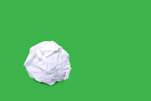 crumpled paper ball white on green background and copy space, rough paper ball isolated on green background, white paper ball waste