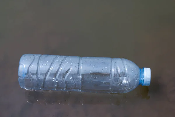 waste plastic bottles float on the water surface, water pollution with garbage plastic, waste bottles plastic