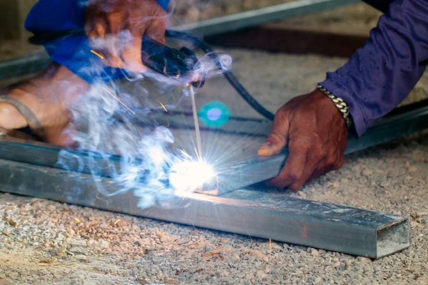 welder and welding sparks, construction and metal work industrial concept, metal welding with sparks, laborer or labor day concept