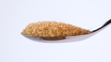 granulated brown sugar in spoon and pouring, sugar crystals, food material, sugar industry, dessert, culinary, nutrition, sweetness, risk of diabetes, sugar control, health awareness