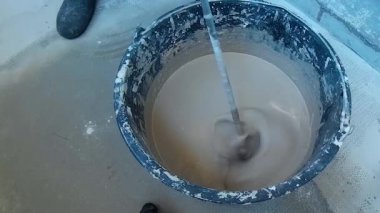 Beton uzun matkap ile karıştırma. İşçi Beton karıştırma.