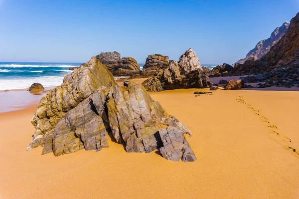 Rock on coastline of sandy Adraga beach, Portugal coast — Stock Photo, Image