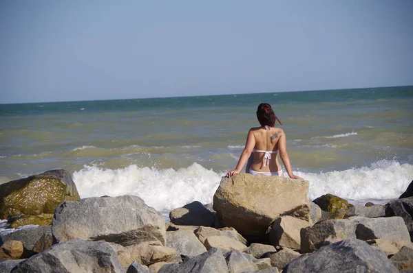 Girl with a tattoo on the background of the sea