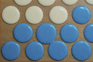 Blue and white Raw macarons before oven clipart