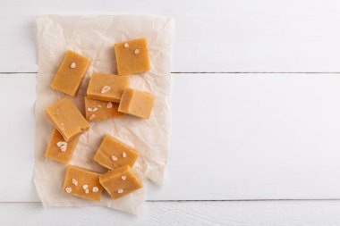 Beyaz rustik arka plan üzerinde taze karamel fudge şekerler