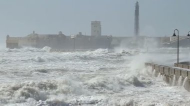Dalgalar okyanus Cadiz İspanya, deniz kenarındaki sete karşı sert kırma çalışırken bir dalga yakalama ağır çekim görüntüleri üzerinden hareket kümesi.