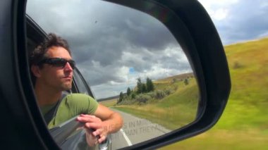Idaho Falls için gidiş aracın yan ayna üzerinde koyu tonları ile adam