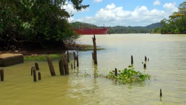 Panning Shot Red Ship Passing Brown Watered Panama Canal — Stok Video