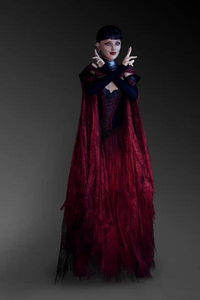 在黑色和红色的黑色和红色的铸造魔术法术的吸血鬼女巫或女巫 — 图库照片