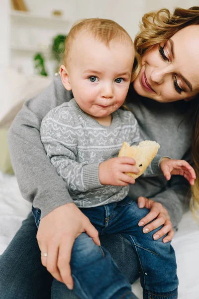 Beautiful young mother holding her cute son — Stock Photo, Image
