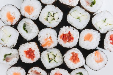 Top view of sushi maki rolls with salmon and cucumber and other 