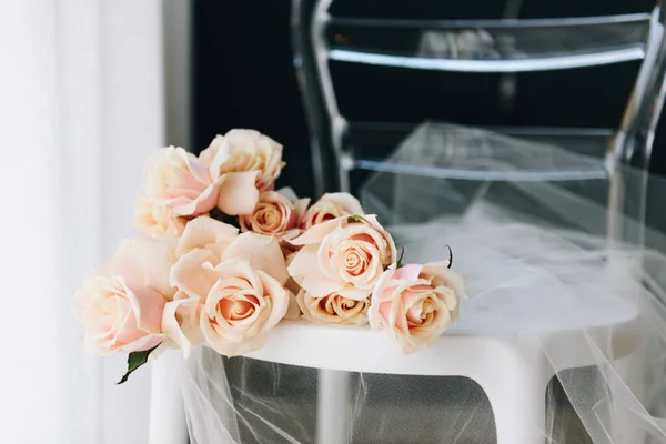 Delicata immagine femminile di un bellissimo bouquet di rose su una sedia con tessuto tulle trasparente, primo piano o primo piano — Foto Stock