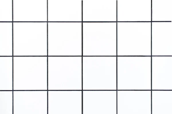 Closeup shot of small white square tiles with black grout lines, close up of tiled bathroom wall as geometric graphic background or backdrop — Stock Photo, Image