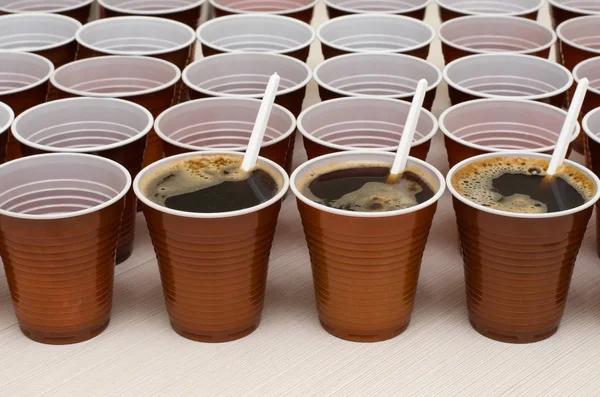 Brown plastic cups for coffee, cocoa, hot chocolate. Photo close up