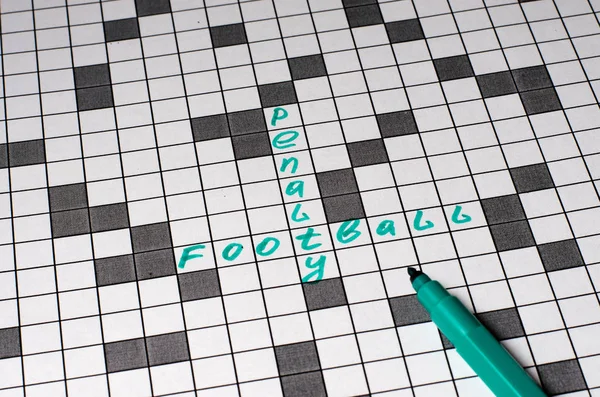 Penalty football. Text in crossword. Green letters. Close-up