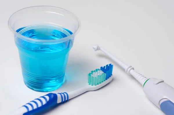 Dental oral irrigator, toothbrush, mouthwash. On a white backgro — Stock Photo, Image