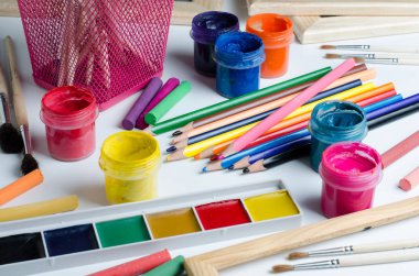 Çizim için aksesuarlar. Fırçalar, boyalar, renkli kalem, tebeşir. Yakın çekim