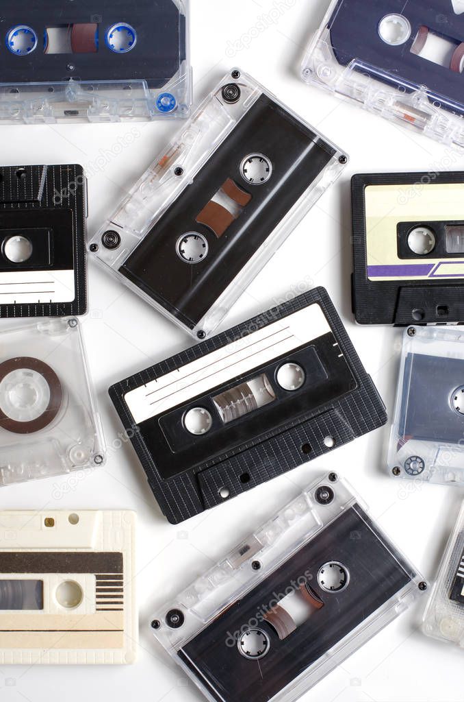 Old audio cassettes on white background. Flat top view. Vertical phot