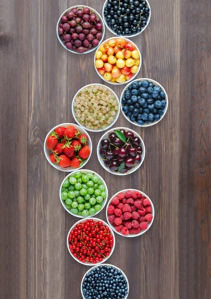 Yuvarlak tabakta bir çift böğürtlen. Kahverengi ahşap arka plan. Düz üst görünüm