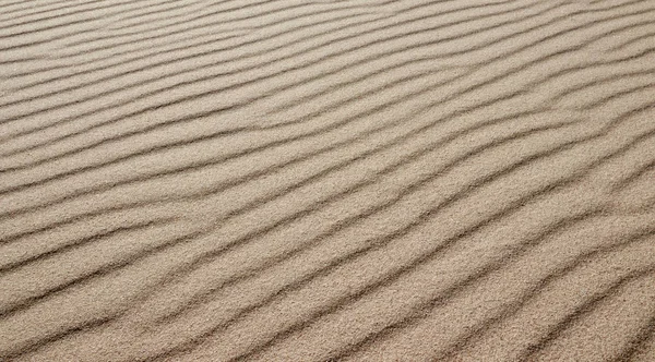 Sable sur la plage comme fond ou texture - Modèle de sable pour — Photo