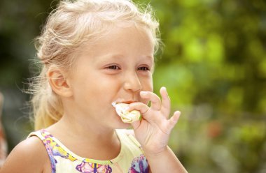 Sevimli küçük Kız renkli arka plan üzerinde Dondurma yeme