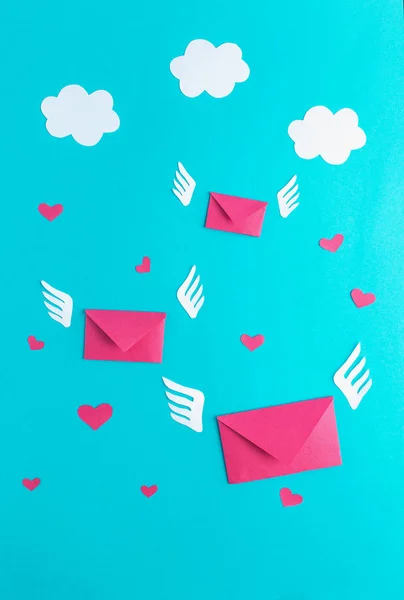 Three flying letters from paper, message, valentines day, hearts, blue background, wings, minimalism