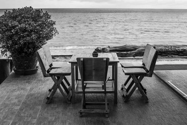 Black and white pictures, sea view seats, it looks lonely.
