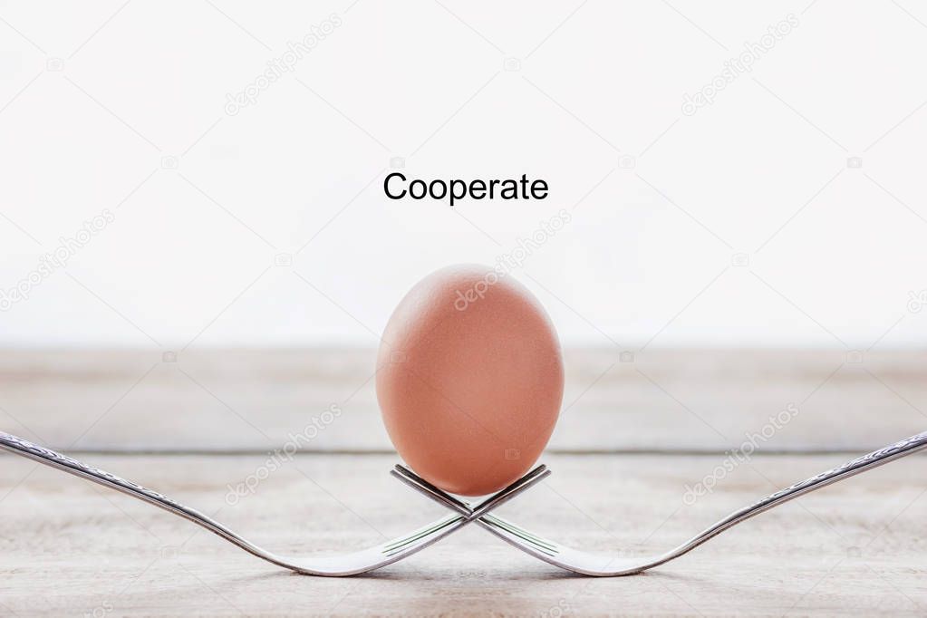 Egg on the fork with text cooperate business concept.