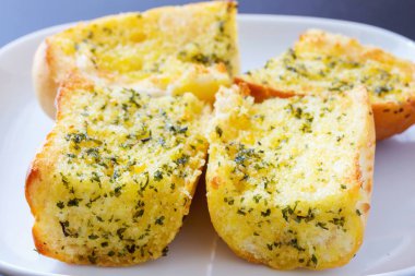 Sarımsak ve bitkisel ekmek dilimleri.