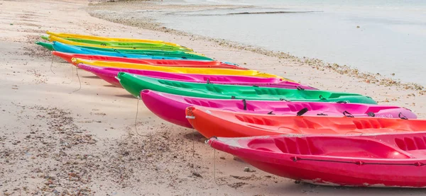 Kayak with paddle and life jacket Parked on beautiful beaches, popular sports and water recreation