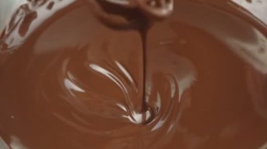 Çikolatayı kapat. Eritilmiş sıvı siyah çikolatayla çırpıcıyı karıştırıyorum. Sıvı sıcak çikolata girdabı. Şef tatlı ve sos hazırlar.. 
