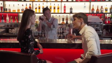 Barmenler, işten sonra takılan gençlere içki hazırlayıp servis ediyorlar..