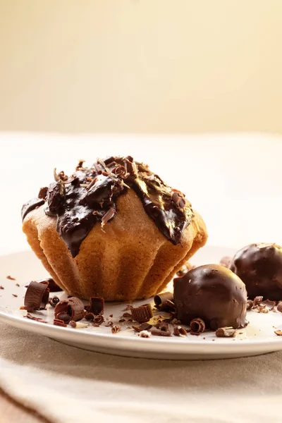 Cupcake drizzled with chocolate, chocolate candies, chocolate chips. Dessert for lovers of sweets homemade