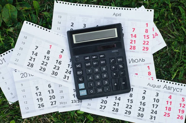 Paper sheet with text TAX DEADLINE, calculator and notebooks on wooden table